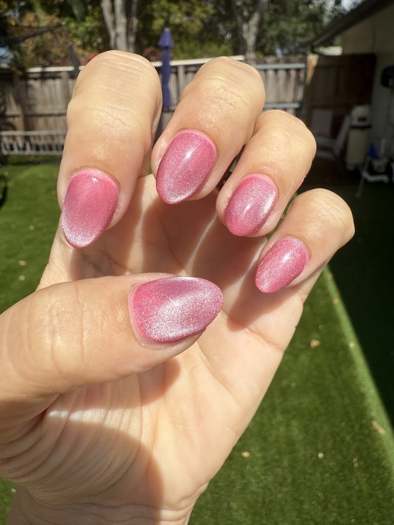 Nail technician shaping acrylic extensions